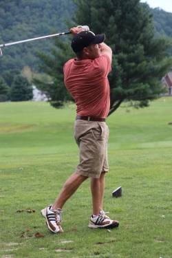action shot of golfer taking a swing